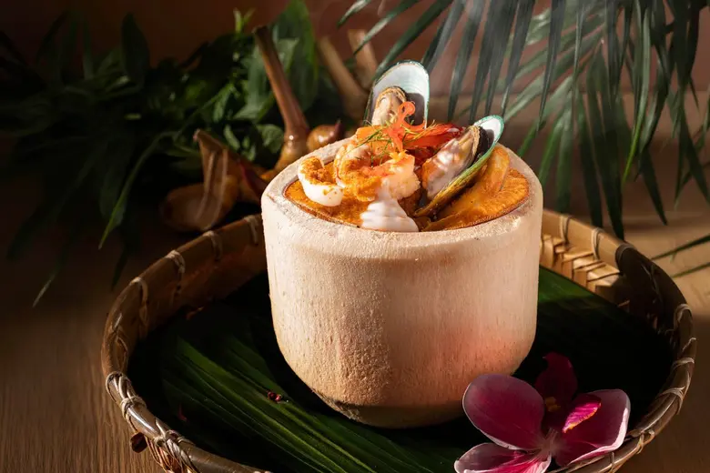 Experience Flavourful Thai Cuisine with Steamed Seafood Curry Custard in Young Coconut at Plate Restaurant